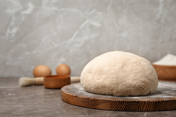Fresh raw dough ball on wooden board