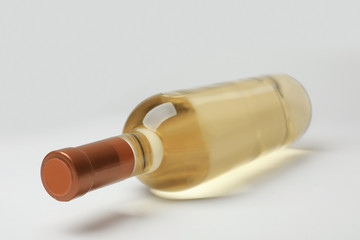 Bottle of expensive white wine on light background