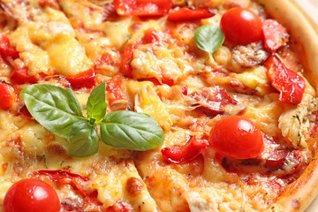 Delicious pizza with sausages and tomatoes, closeup