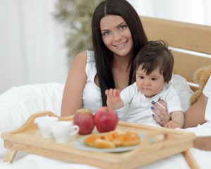 Family having breakfast in bed at home