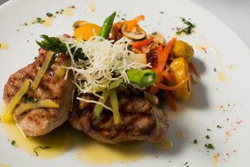 Meat with potato and vegetables on a white table, Fusion Food