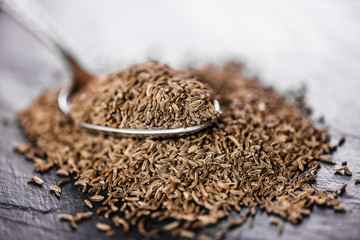 dry cumin seeds on a metal spoon