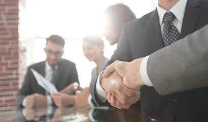 handshake of business partners in conference room