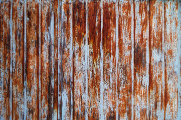 Old metal surface with traces of brown paint and corrosion, metal texture.