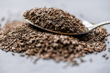 dry cumin seeds on a metal spoon