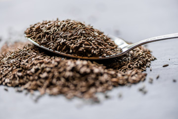cumin seeds on metal spoon heap 