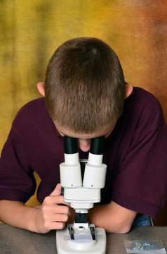 Young Boy Using a Microscope