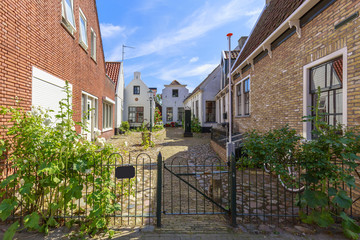 Street view with typical houses and architecture in Den Burg, village on the wadden island Texel.