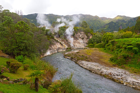 Fumaroles along a waterway created by springs in central part of Furnas village on Sao Miguel Island, Azores, Portugal. Lush flora in area of the easternmost active trachytic volcano on the island.