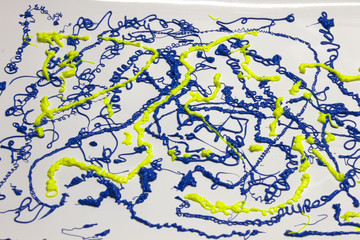 Neon Blue and Yellow paint splatter on a White background