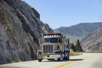 Semi truck with trailer driving on highway