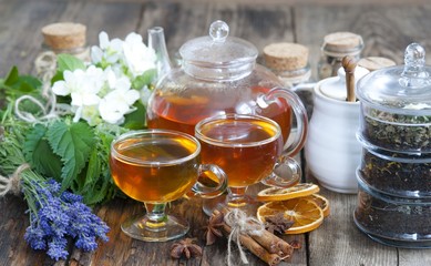 Cup of herbal tea with wild flowers and various herbs