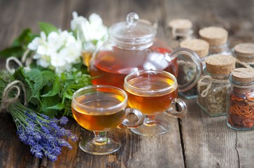 Cup of herbal tea with wild flowers and various herbs 