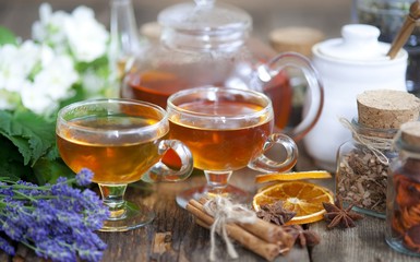 Cup of herbal tea with wild flowers and various herbs