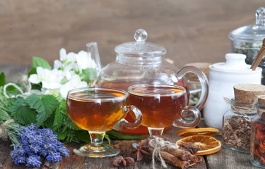 Cup of herbal tea with wild flowers and various herbs 