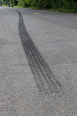 Traces of black tire brakes on the road.