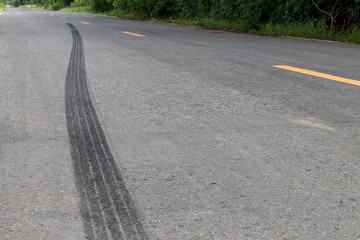 Traces of black tire brakes on the road.