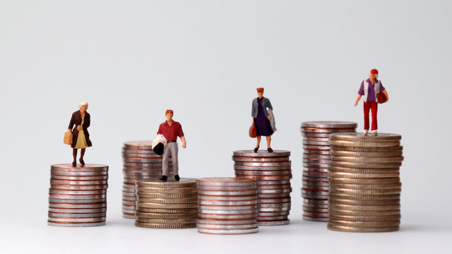 Miniature People Standing On Piles Of Different Heights Of Coins. The Growing Concept Of Income Gap.