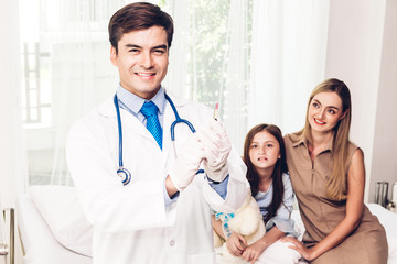 Doctor in protective gloves giving injection with little girl child in hospital.healthcare and...