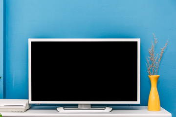 Smart Tv mockup on blue wall background in modern living room