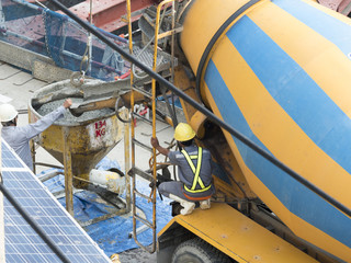 engineer fill concrete in to tank from concrete mixer truck in building construction plant