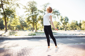 young athletic girl doing exercise, posing in a jump, can be used for advertising, text insertion