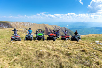 Obraz premium Friends driving off-road with quad bike or ATV and UTV vehicles