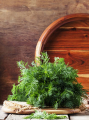 Fresh dill on the old wooden table, rustic style, selective focus