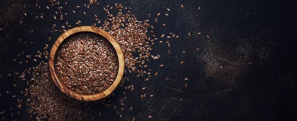 Fototapeten Raw flax seeds in bowl, stone background, top view © 5ph