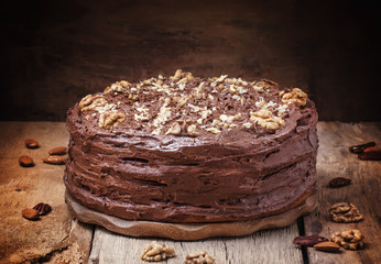 Homemade chocolate cake with nuts, rustic background, selective focus