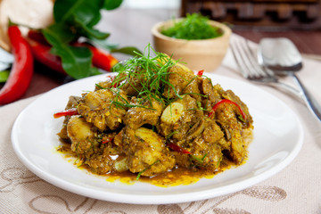 Fried pork bones spicy with yellow curry paste on dish thai style food