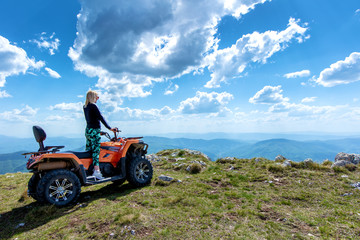 Friends driving off-road with quad bike or ATV and UTV vehicles