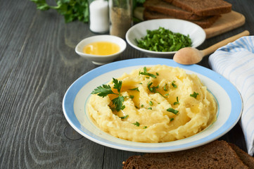 Mashed potatoes with fresh parsley and butter on a plate