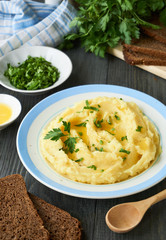 Mashed potatoes with fresh parsley and butter on a plate