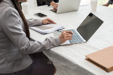 Asian businesswoman working with laptop in the conference room. She are business startup and analyzing.  brainstorming, teamwork, meeting concept..