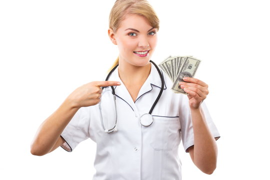 Woman doctor with stethoscope showing currencies dollar, corruption, bribe or paying for care concept
