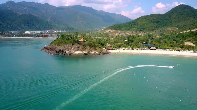 yacht sails on ocean against magnificent hilly landscape