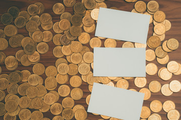 Blank business card or name card with copy space for add text name address and company logo, stack of coin on working table, financial company concept.