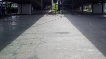 Shadow of bridge on concrete football field