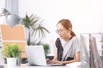 Young asian business woman working with computer .