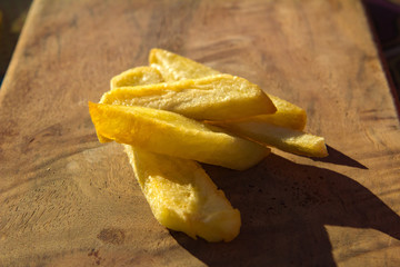 french fries on a wooden board in a cafe restaurant