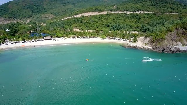 motorboat turns around and parachutist on ocean water