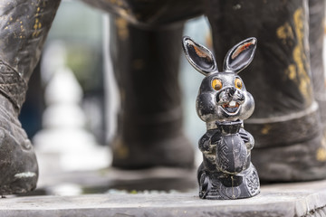 Close up of bronze metal rabbit bunny decoration in a temple in Hat Yai Thailand