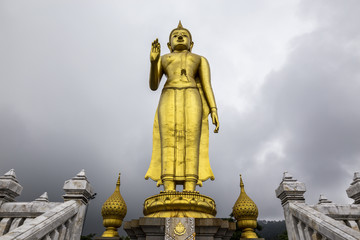 Fototapeta na wymiar Phra Buddha Mongkol Maharaj tallest Golden Standing Buddha at Hat Yai Municipal Park, Hat Yai Thailand