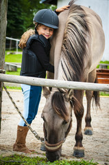 Young horse riding girl, equestrian sport . Horseback girl on field.