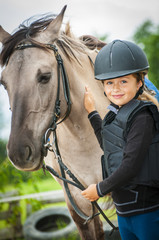 Young horse riding girl, equestrian sport . Horseback girl on field.