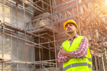 Manager Engineering in standard safety uniform working in a pouring concrete pump on construction site