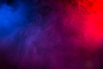 Multi-colored smoke in the form of a cloud on a black background