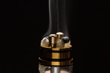 Obraz na płótnie Canvas Vape close-up with smoke on a black background
