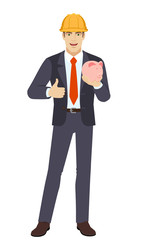 Businessman in construction helmet with piggy bank showing thumb up